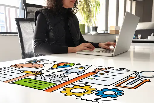 Woman working on her laptop in a colorful desk