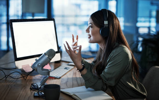 picture of a girl talking to microphone in an office with a laptop