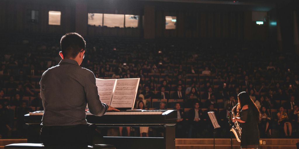 A man on stage playing the piano