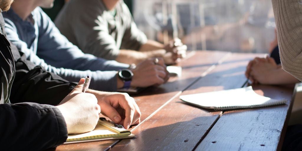 People having a meeting with a wooden table