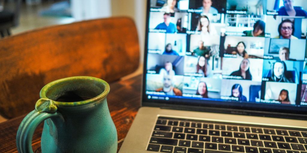 Macbook Pro displaying a group of people having a virtual meeting